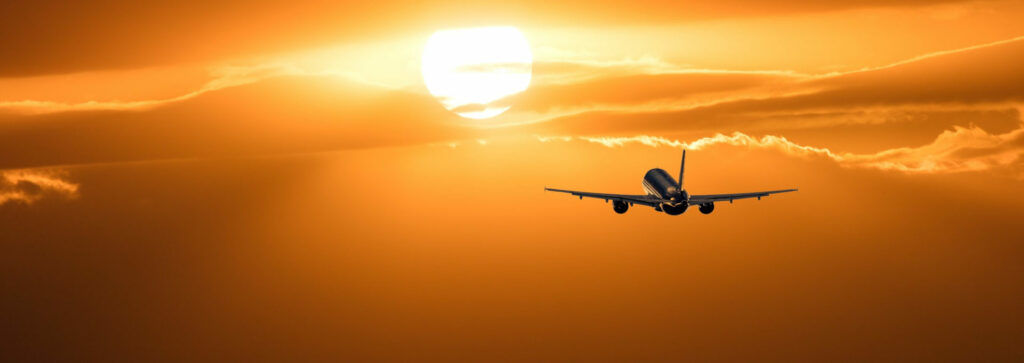 Airliner flying in front of sun